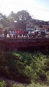 Los ciudadanos arriba del puente miraban curiosos la escena del crimen.