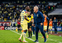 Soccer player and coach arguing on the sideline during a match