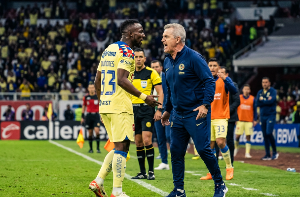 Soccer player and coach arguing on the sideline during a match