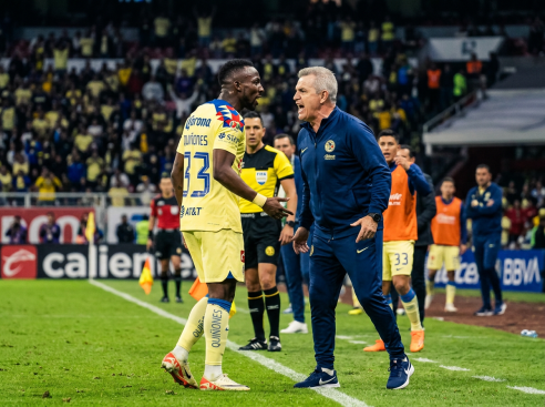 Soccer player and coach arguing on the sideline during a match